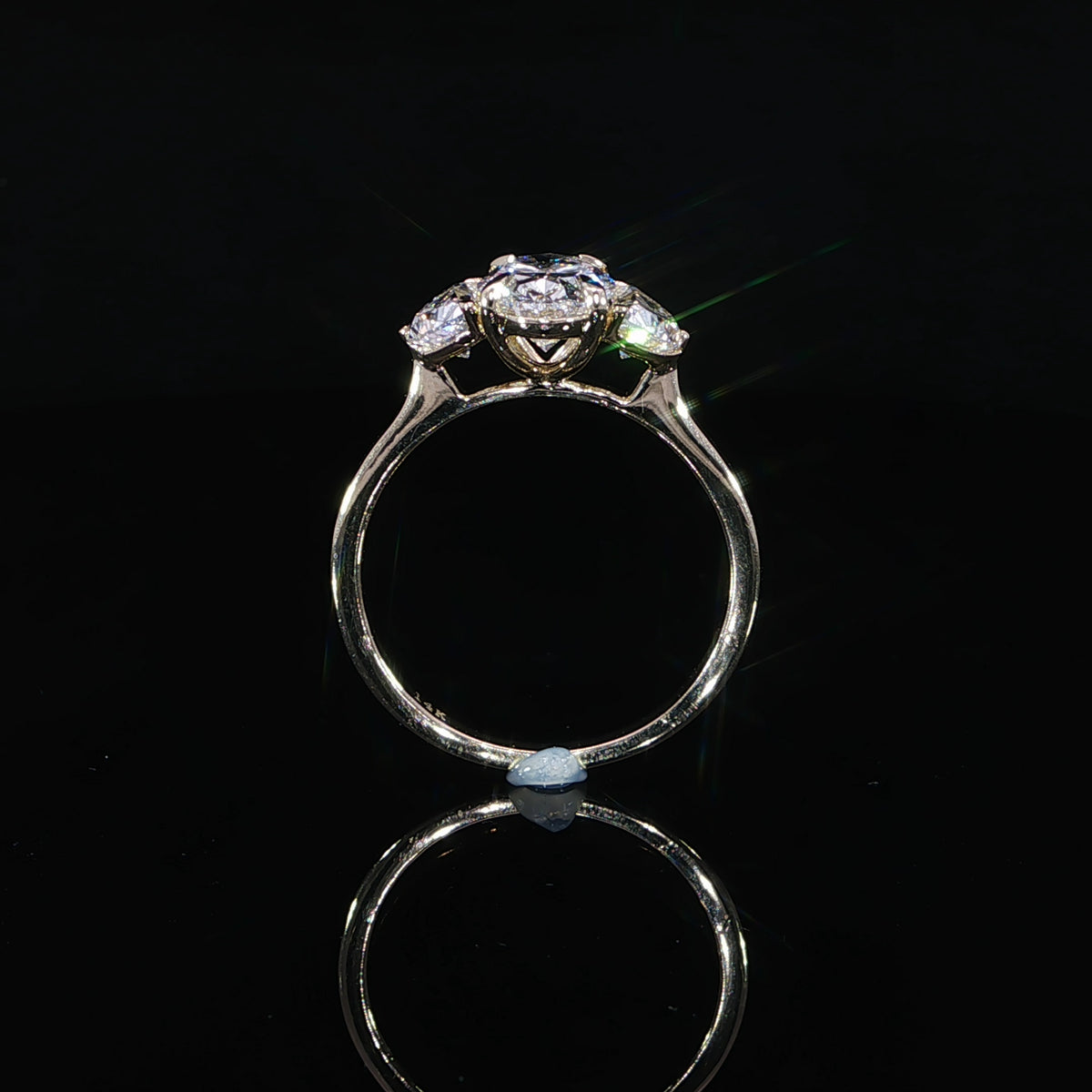 Oval center with half-moon side stones engagement ring with 2.66 ctw.