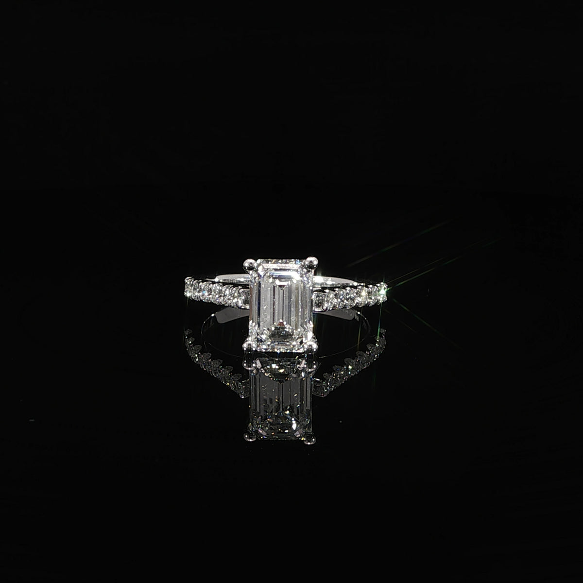 14K white gold engagement ring with a 2.08 carat emerald cut lab grown diamond in a cathedral setting.