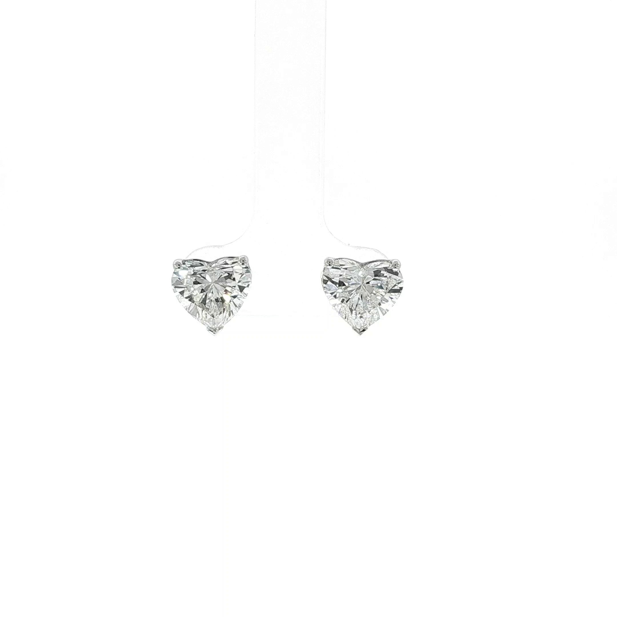 Close-up of 4 CTW lab grown heart shaped diamond earrings