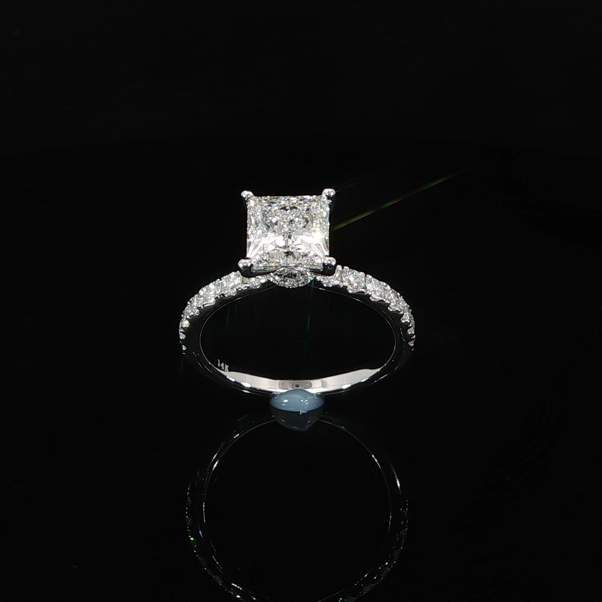 Angled view of 14K white gold princess cut engagement ring showing the 2 carat center diamond and pave band.