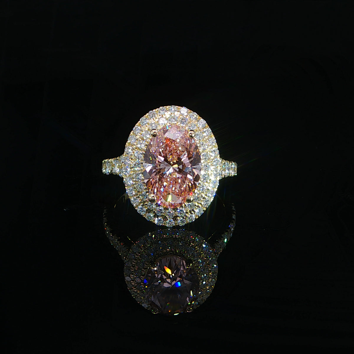 14K yellow gold engagement ring with a 3.00 carat fancy intense pink oval lab grown diamond, split shank, and hidden halo.