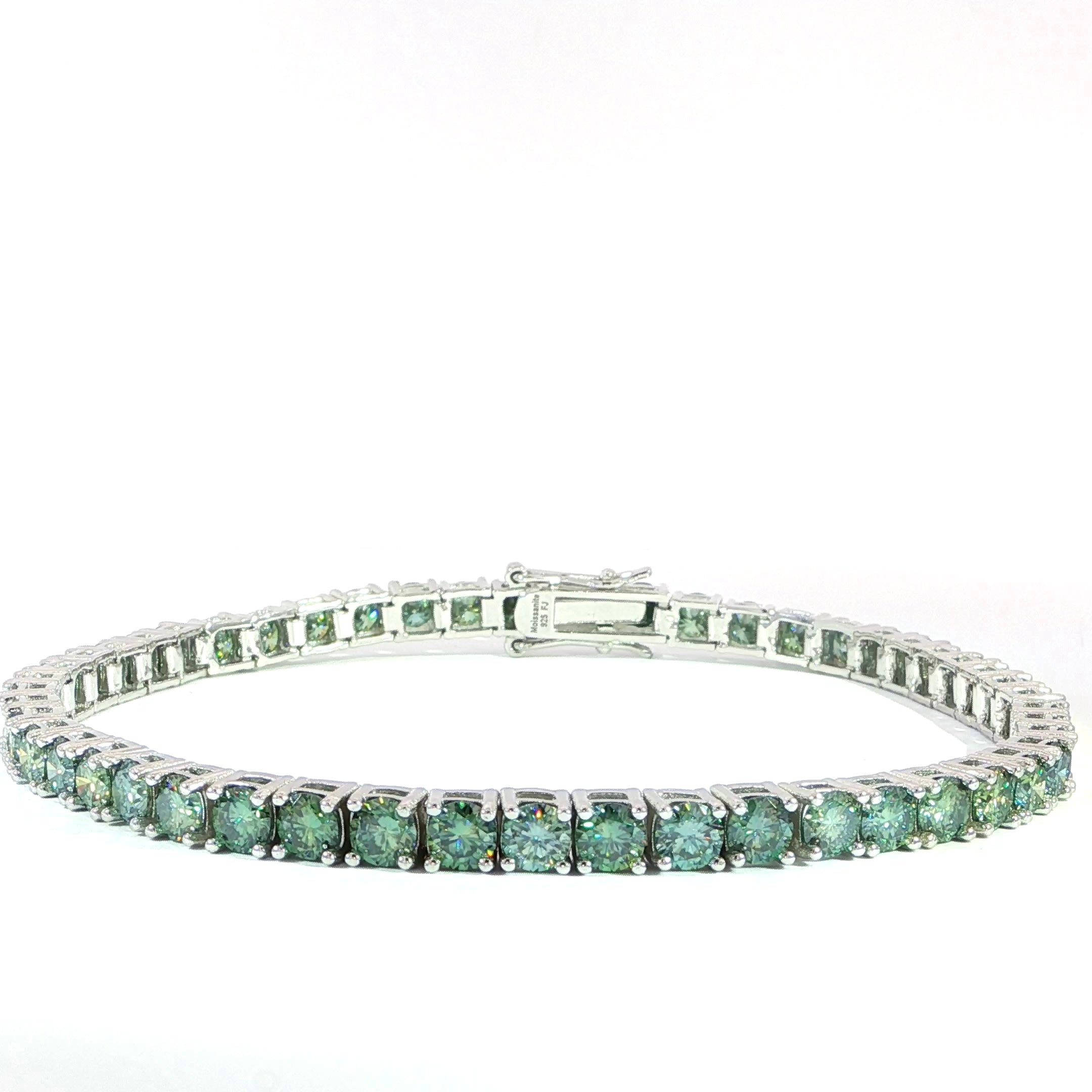 Green colored 4MM moissanite tennis bracelet crafted in polished sterling silver.