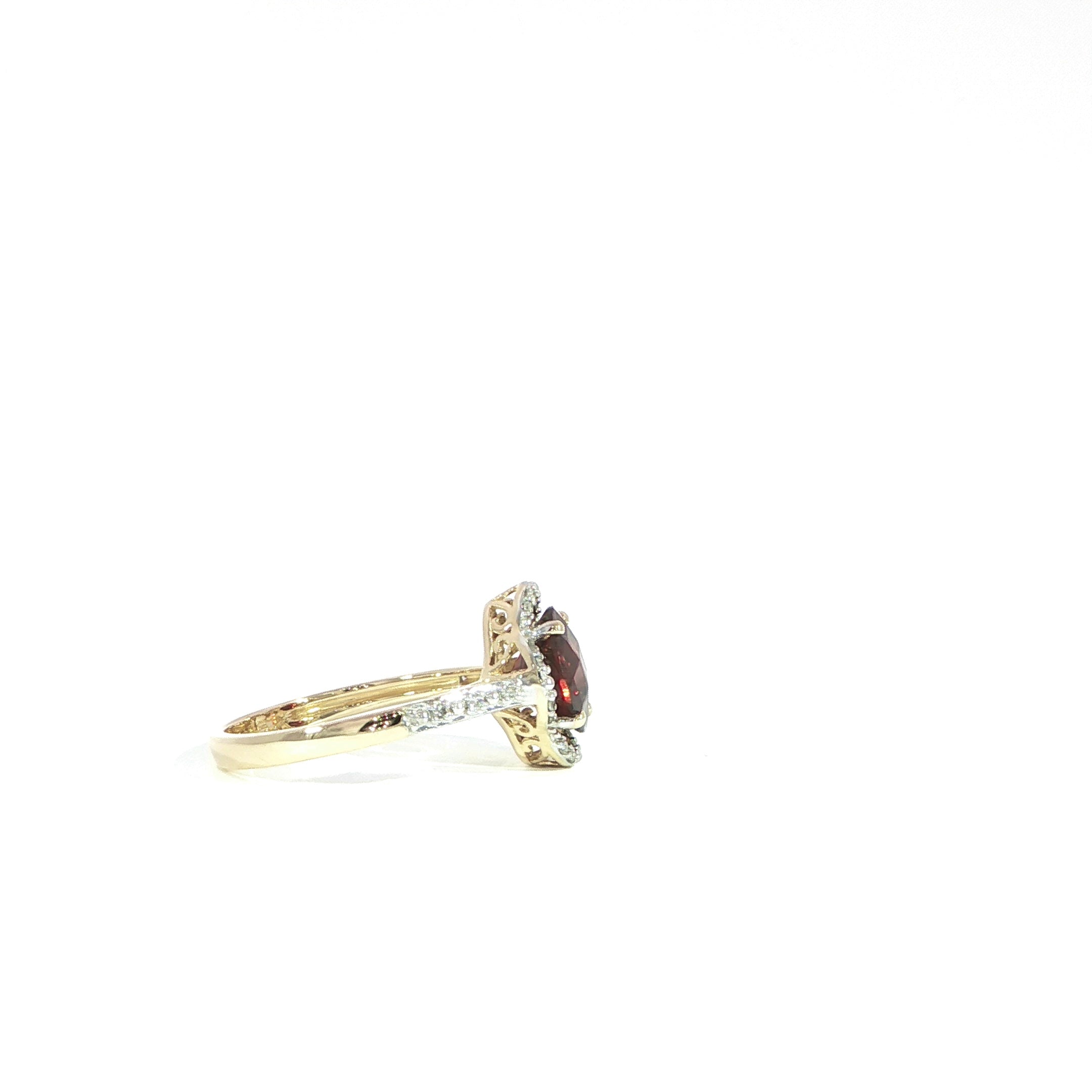 Side detail of garnet gemstone ring with diamonds