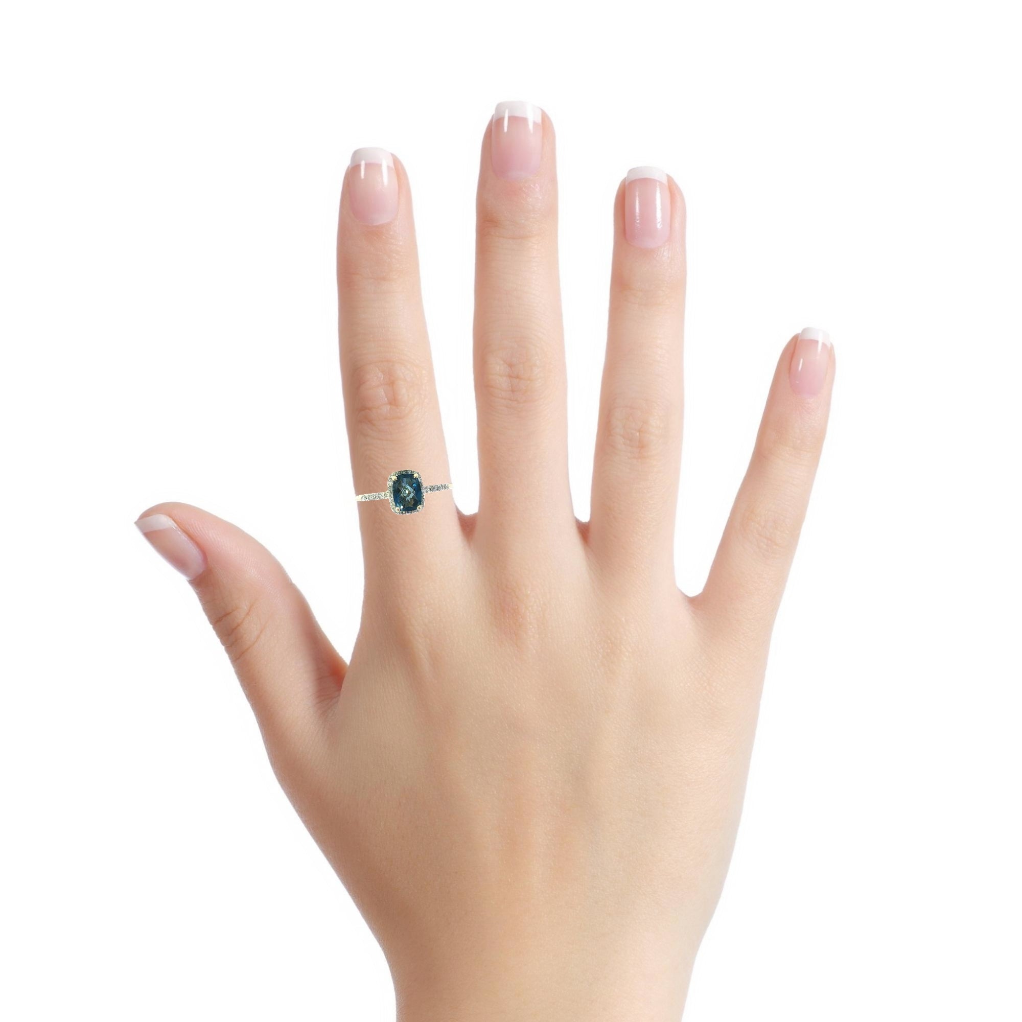 Model wearing 14K gold blue topaz diamond halo ring