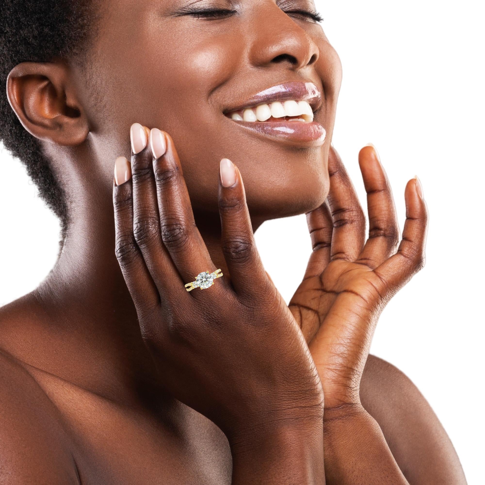 Model wearing round 2 carat lab diamond ring with split shank and side stones