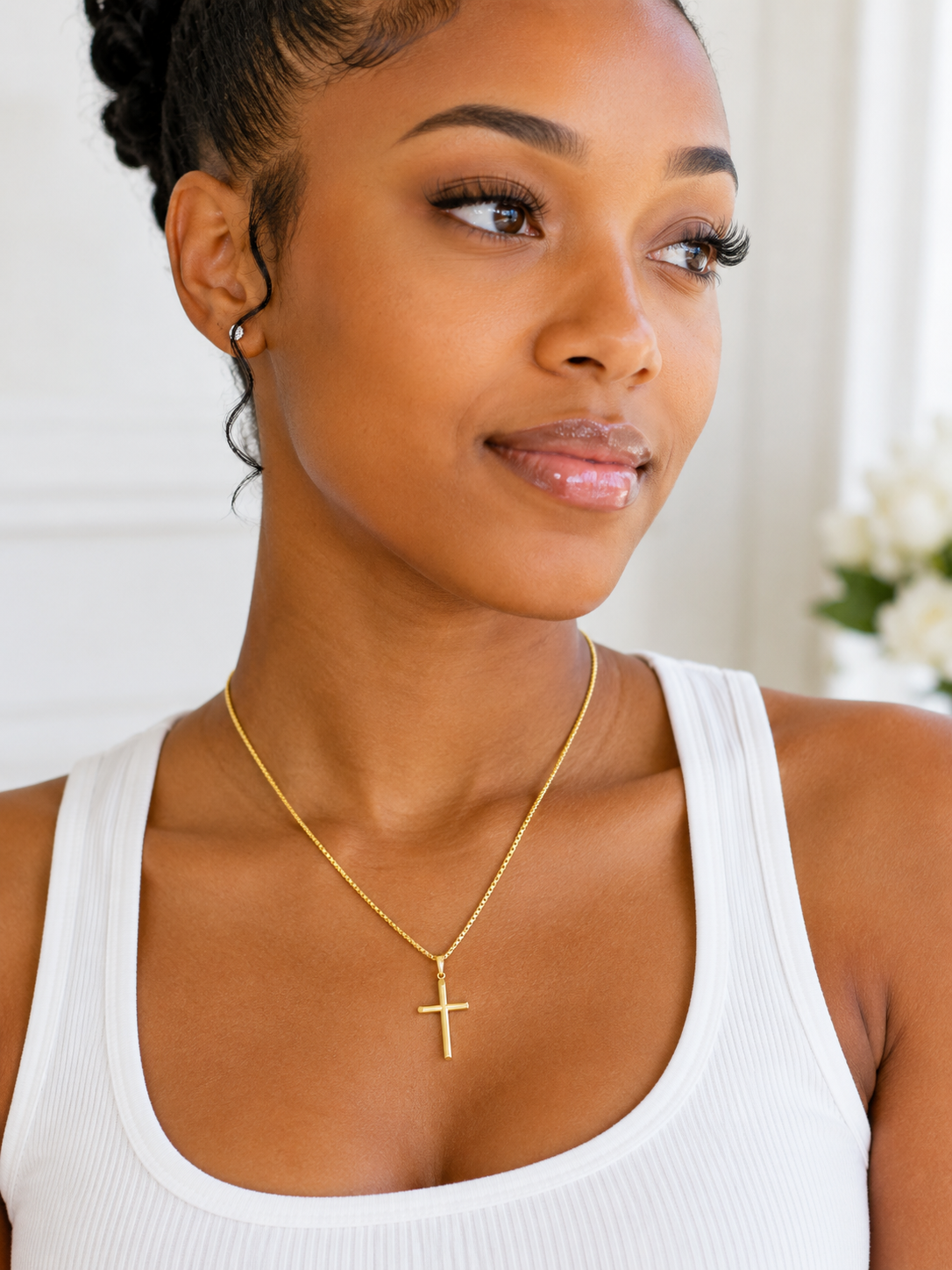 Minimalist 10K gold cross pendant symbolizing faith and devotion.