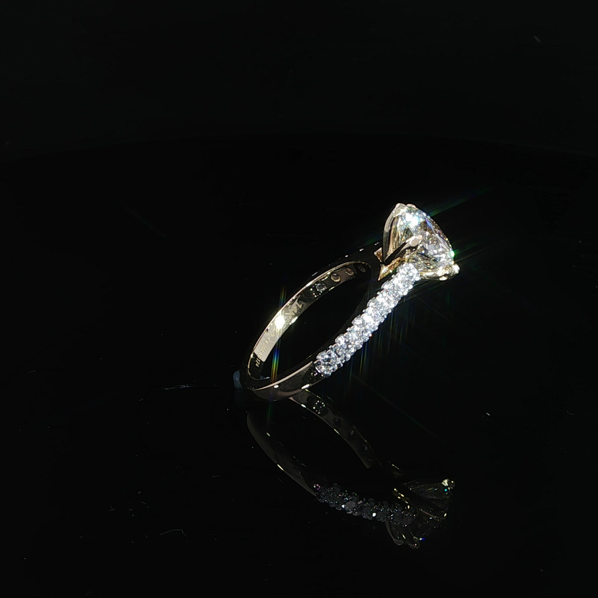 Angled view of 2.50 carat round diamond engagement ring with a pavé cathedral band in 14K yellow gold.