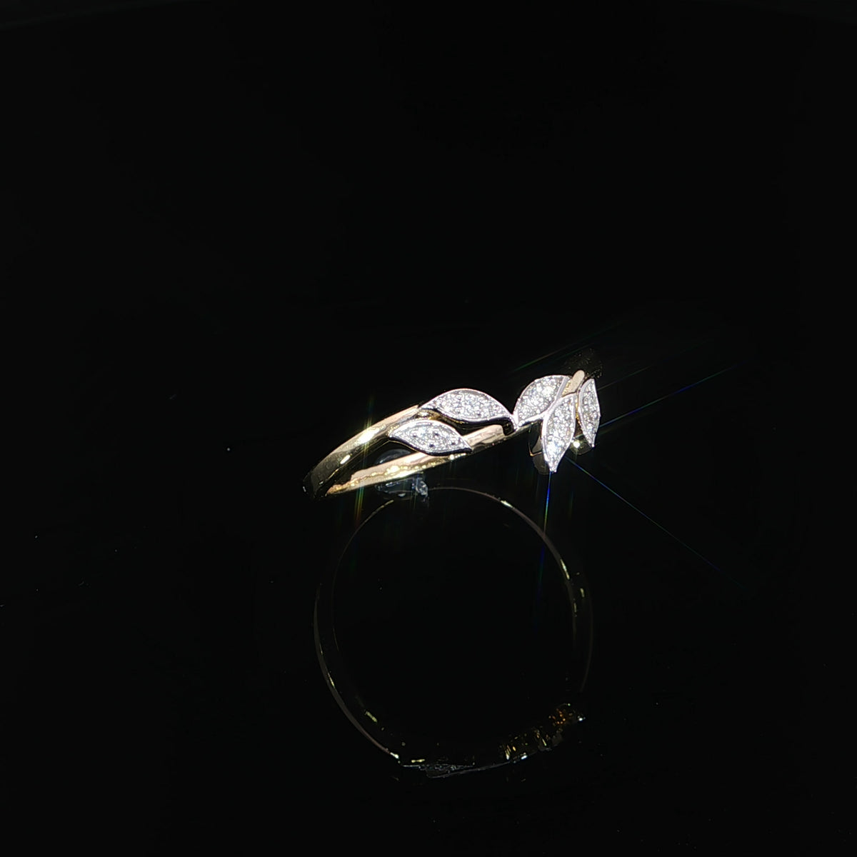 Delicate diamond vine ring in 14K yellow gold with flowing branches and diamond-studded leaves, totaling 0.06 carats.
