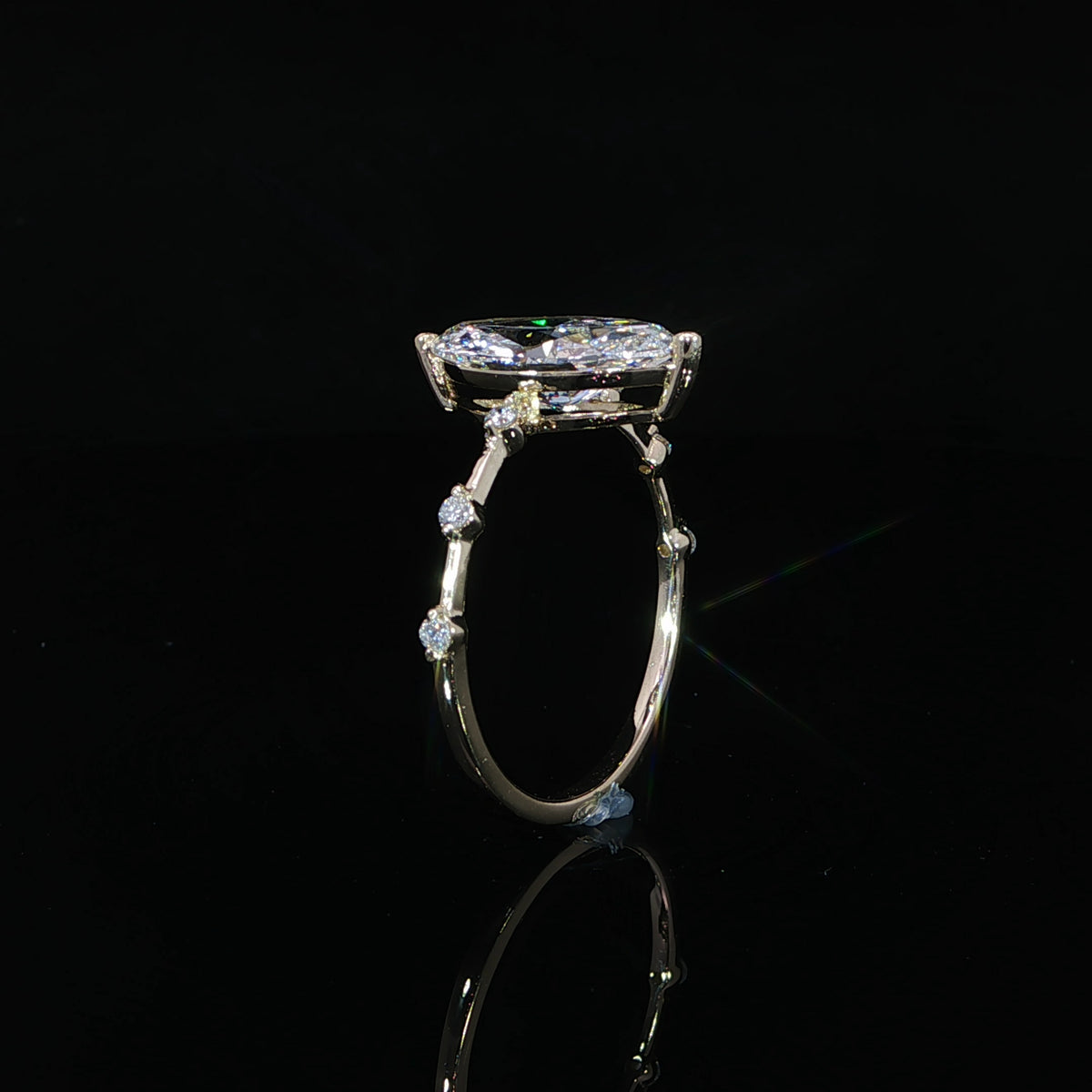 Detailed view of the spaced round diamond stations decorating the slender yellow gold band.