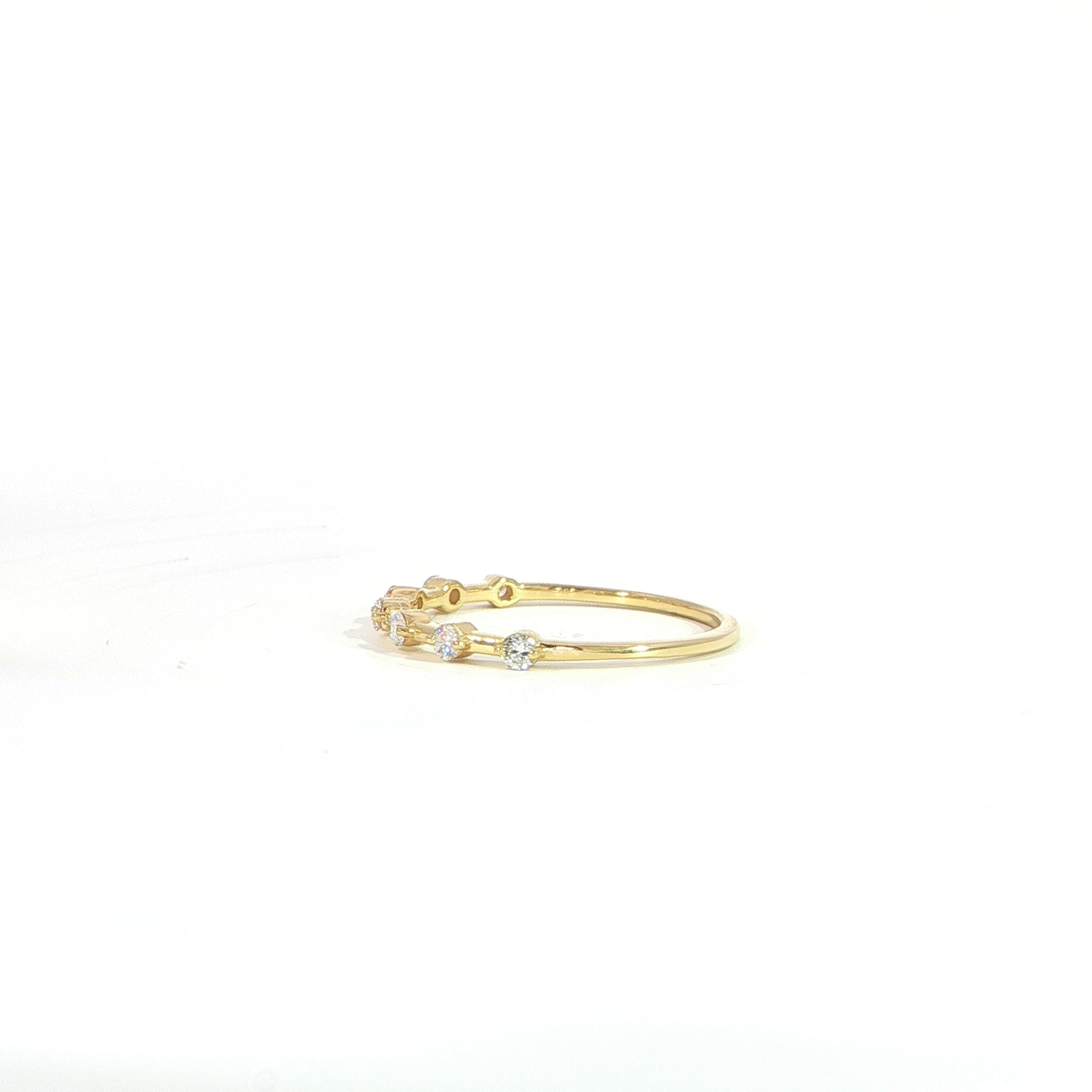 Bezel set diamond station ring with spaced diamonds side view