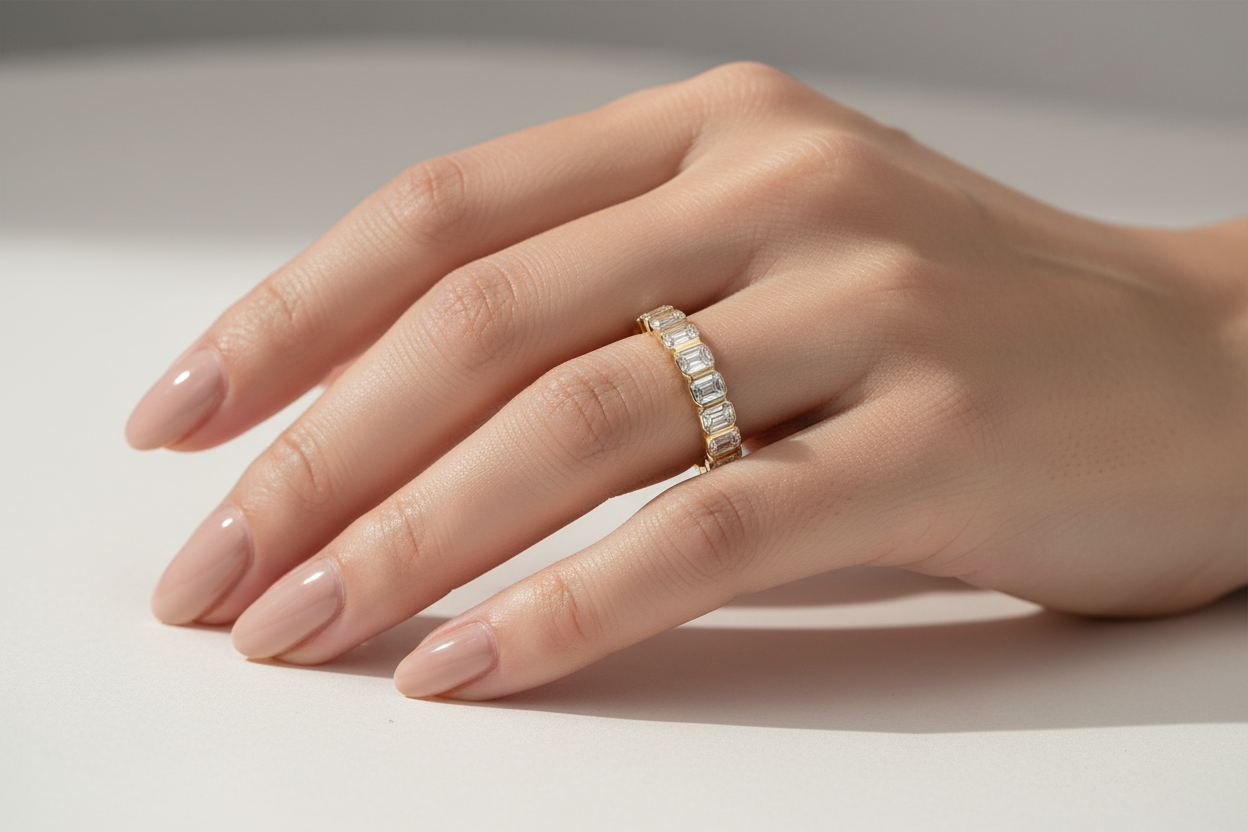 Close-up of bezel set emerald diamond stacking band