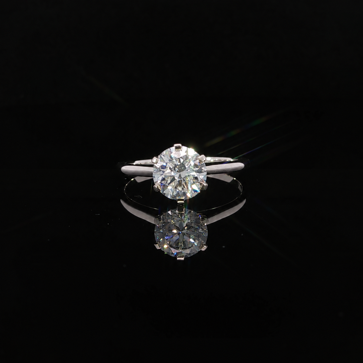 Close up view of a 1.50 carat round lab grown diamond ring in 14k white gold and a 6-prong setting