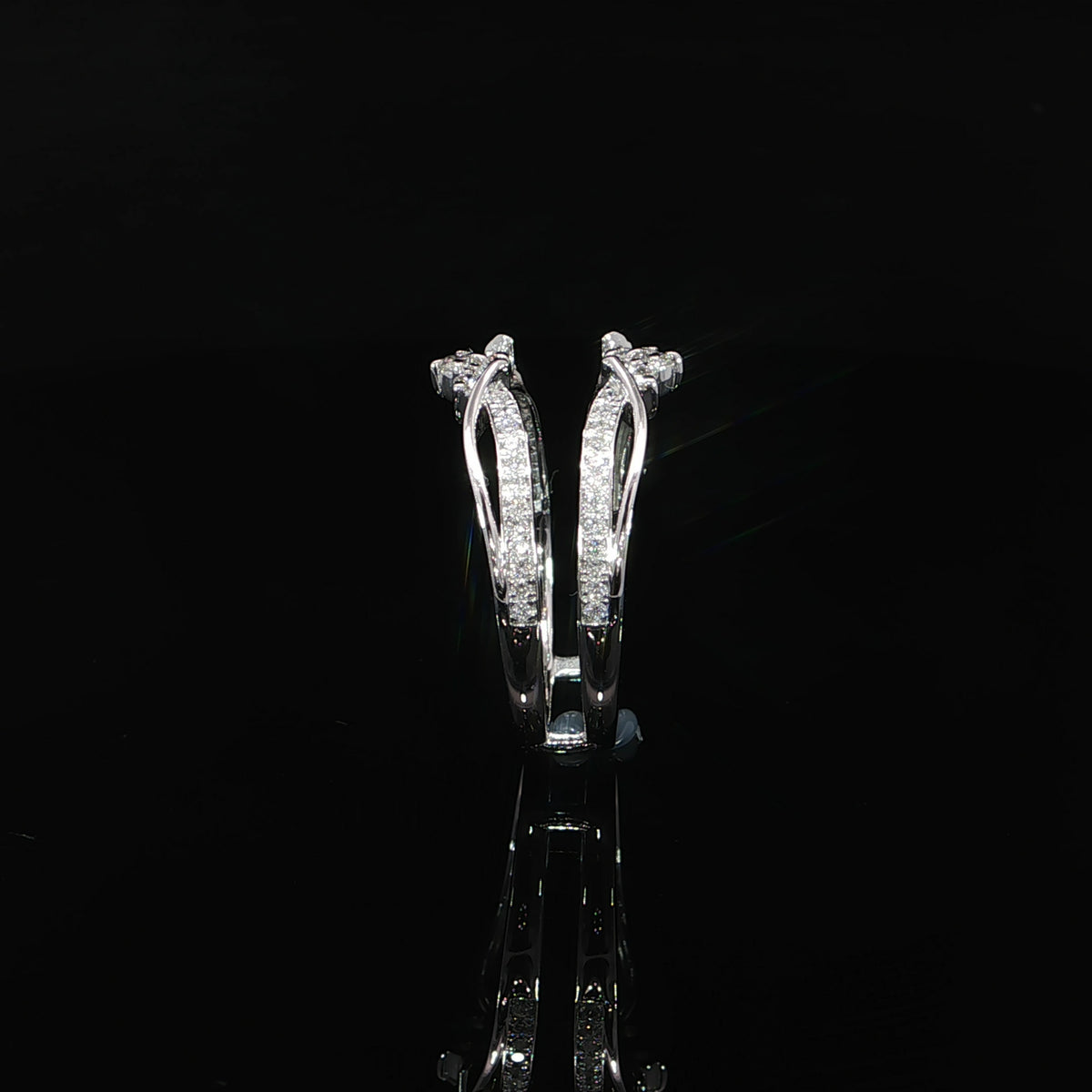 Side profile of a white gold diamond ring enhancer showing connected bands and open curved details