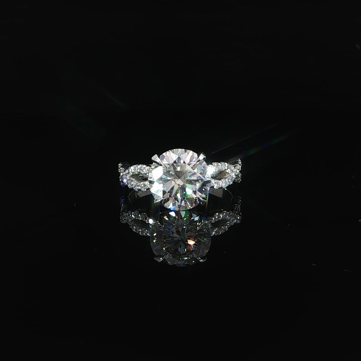 Front view of four-prong round diamond infinity twist engagement ring