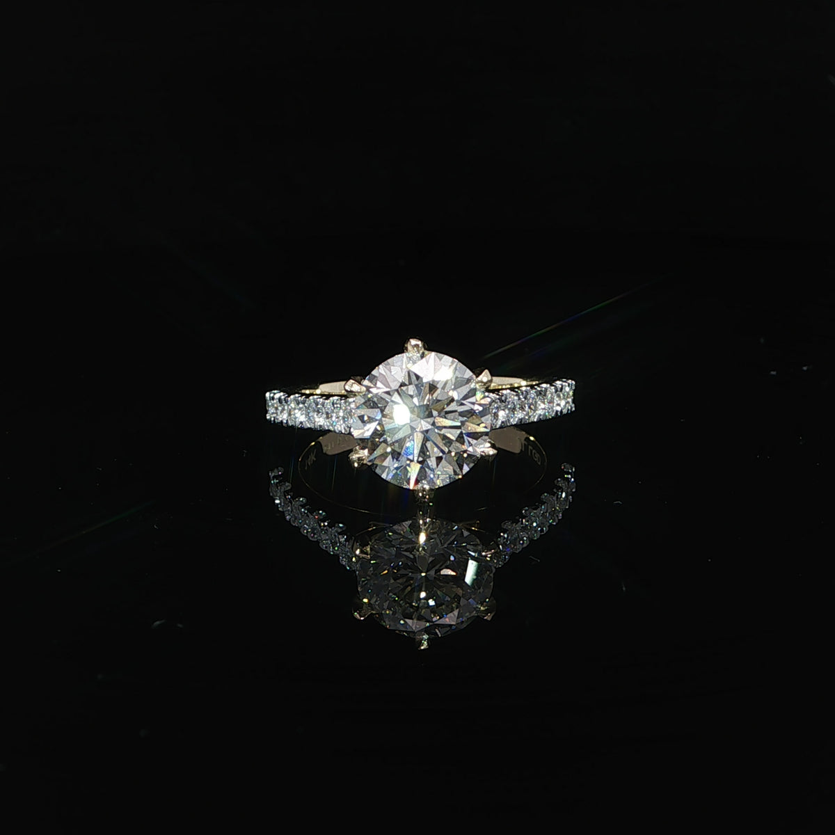 Front close-up view 2.54 carat round diamond engagement ring with a solitaire-style center and pavé diamond accents.