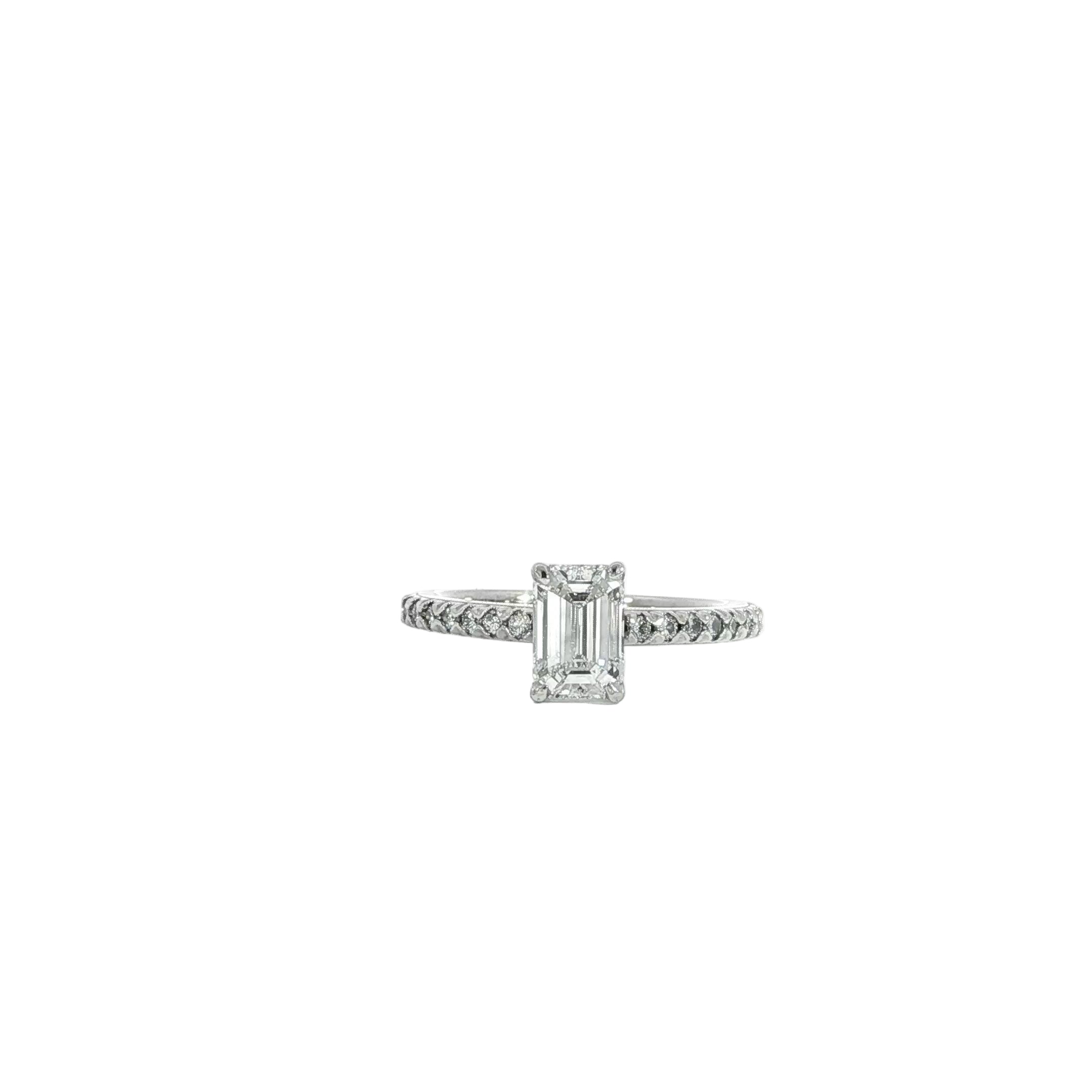 Emerald cut solitaire ring in 14K white gold with pave diamonds