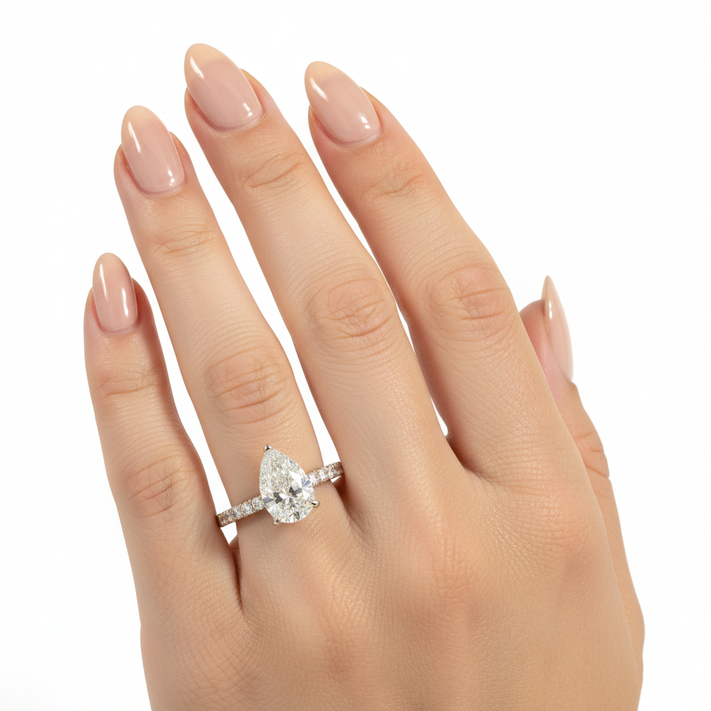 Pear diamond engagement ring with diamond band