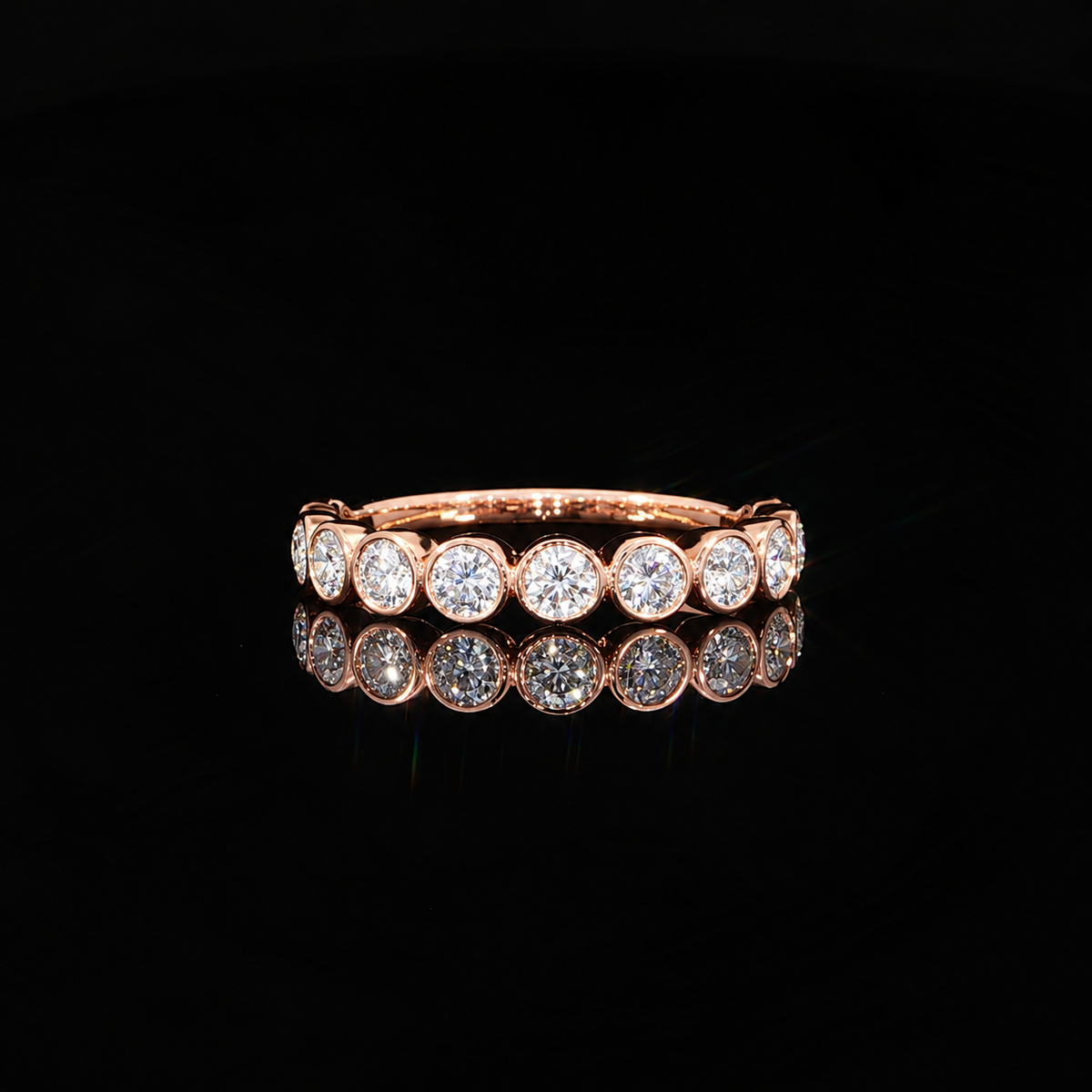 14K rose gold lab grown diamond band featuring brilliant round diamonds individually secured in polished bezel settings.
