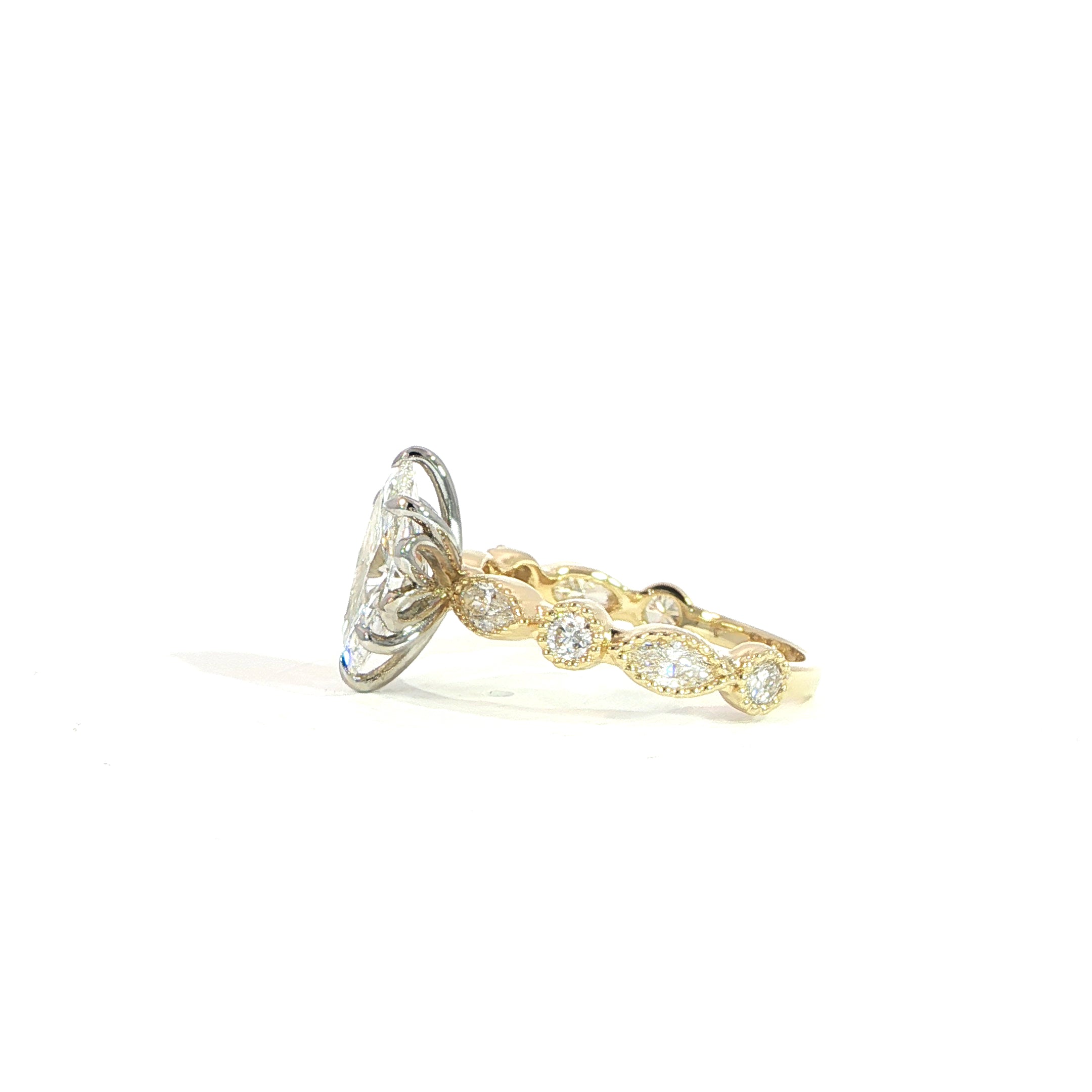 Side view of marquise diamond ring with detailed band