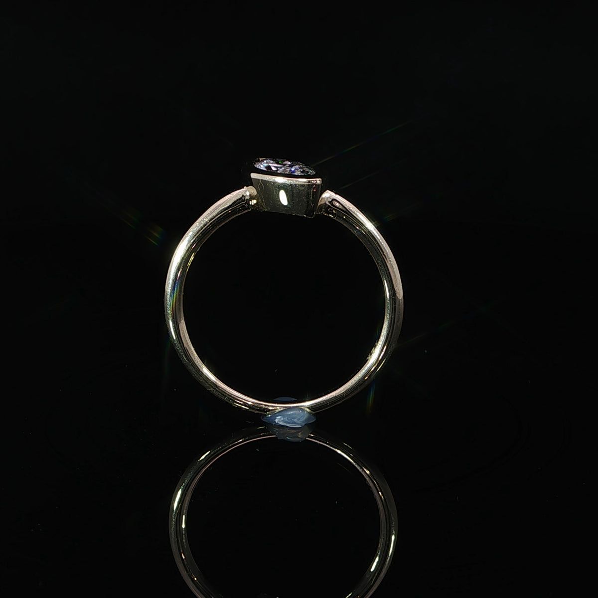 Marquise lab grown diamond engagement ring featuring a sleek full bezel setting and plain yellow gold band.