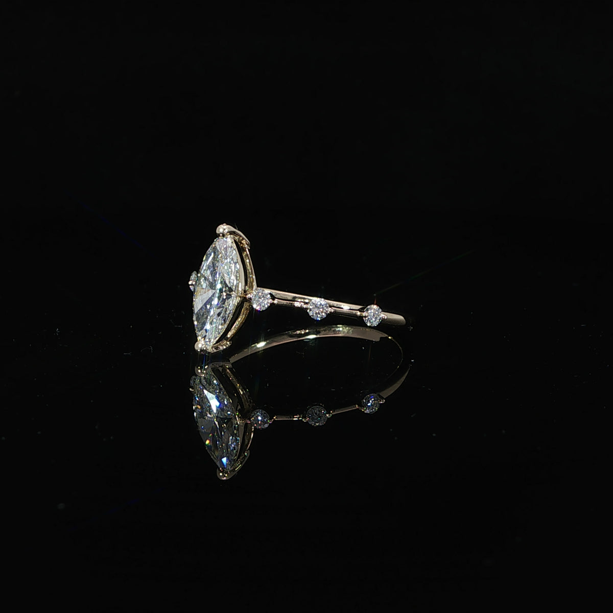 Side profile of a marquise lab-grown diamond ring showing its elevated center-stone setting.