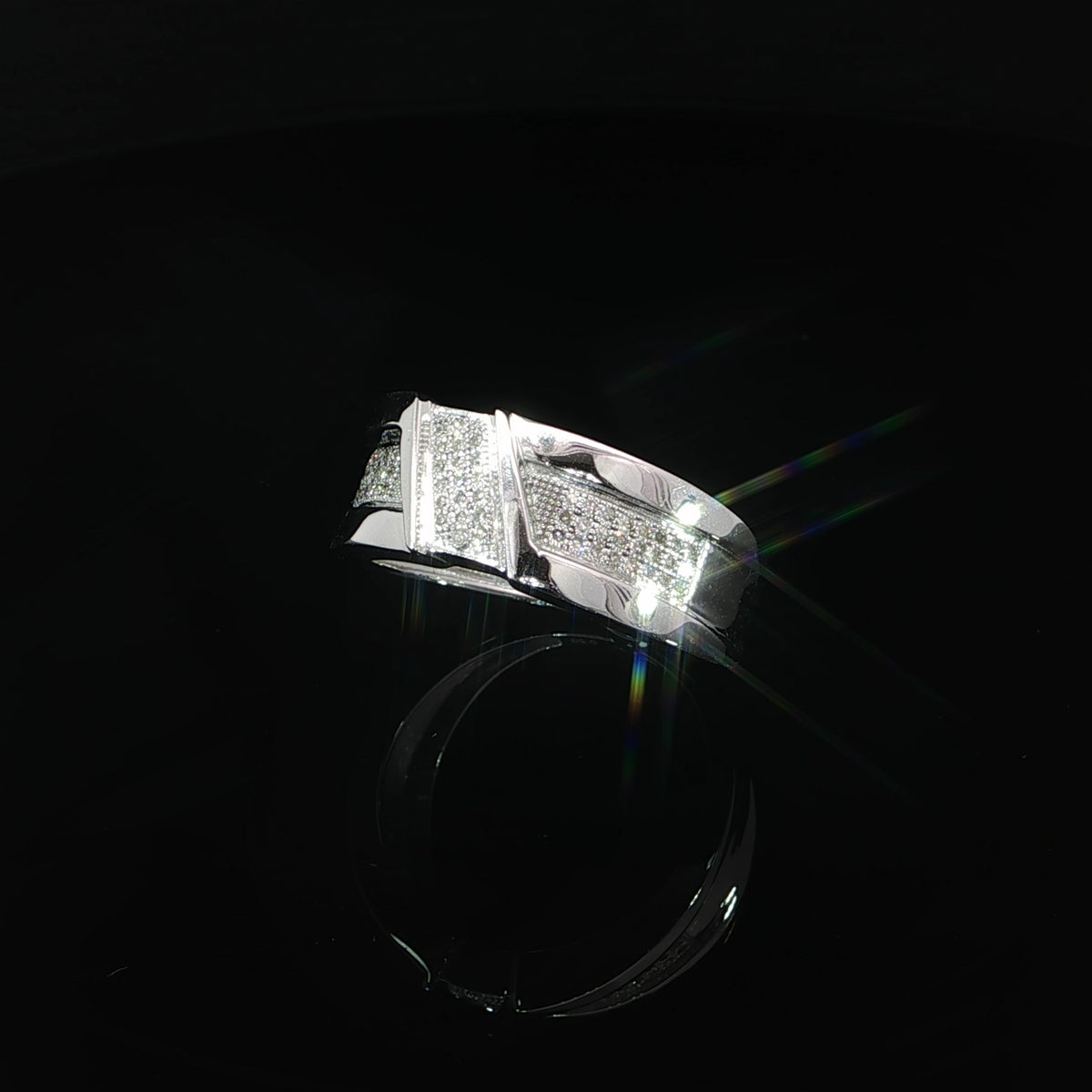 Angled view showing the diamond panels and polished edges of a men’s 10K white gold ring.