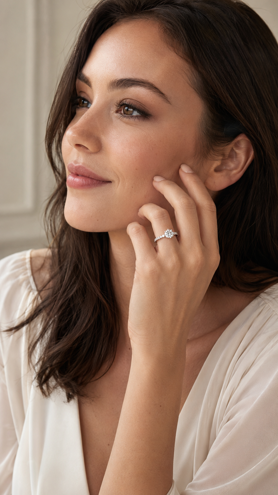 Model wearing round engagement ring with 2.55 total carats of lab-grown diamonds set in 14K white gold.