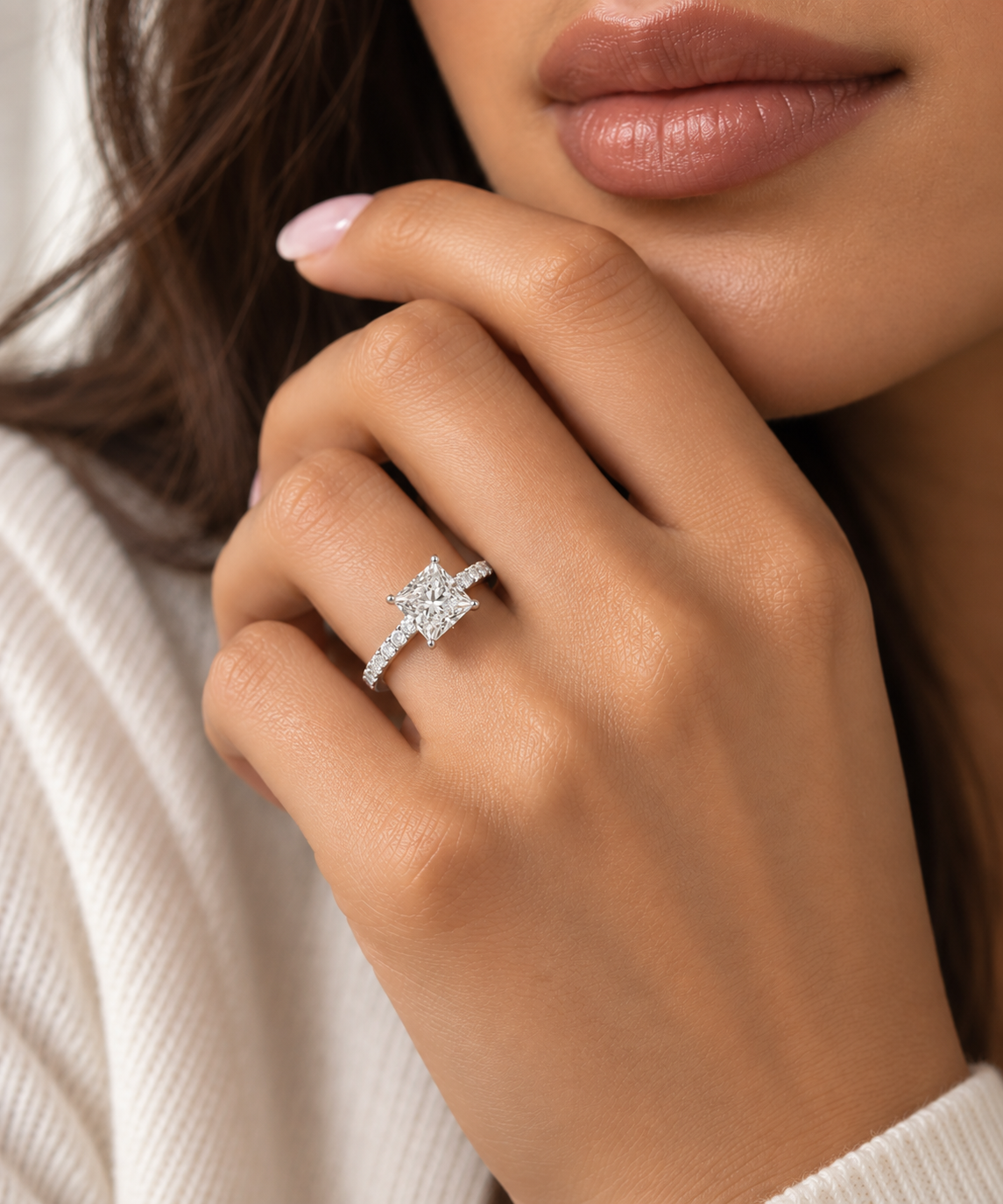 Model wearing a 2 carat princess cut engagement ring showing the center diamond, pave band and white gold setting.