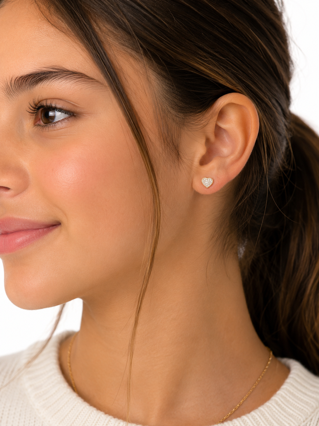 Model wearing 5 x 5.5MM diamond heart stud earrings with secure screw back closure