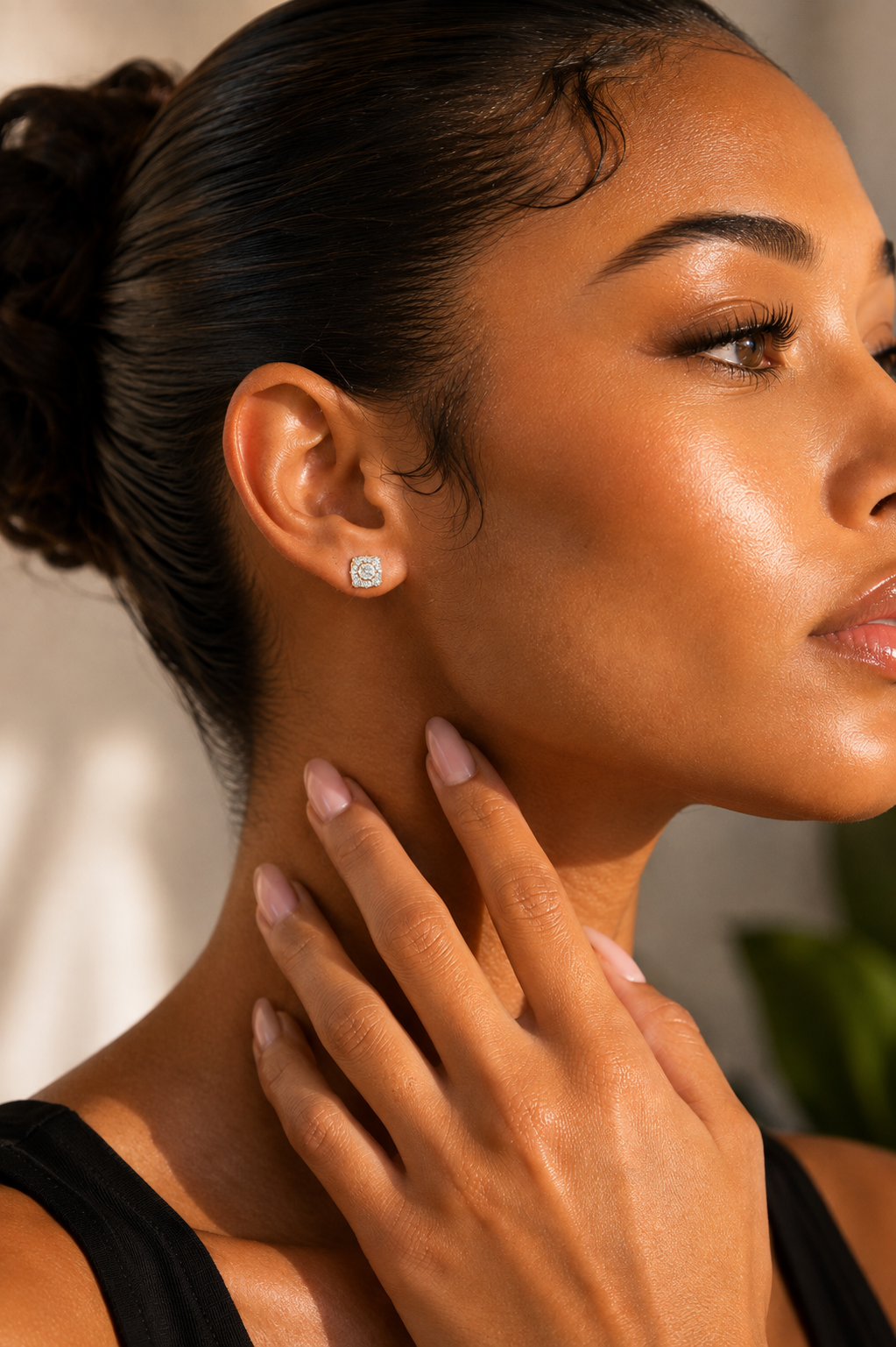 Model wearing 7 mm natural diamond cushion halo stud earrings