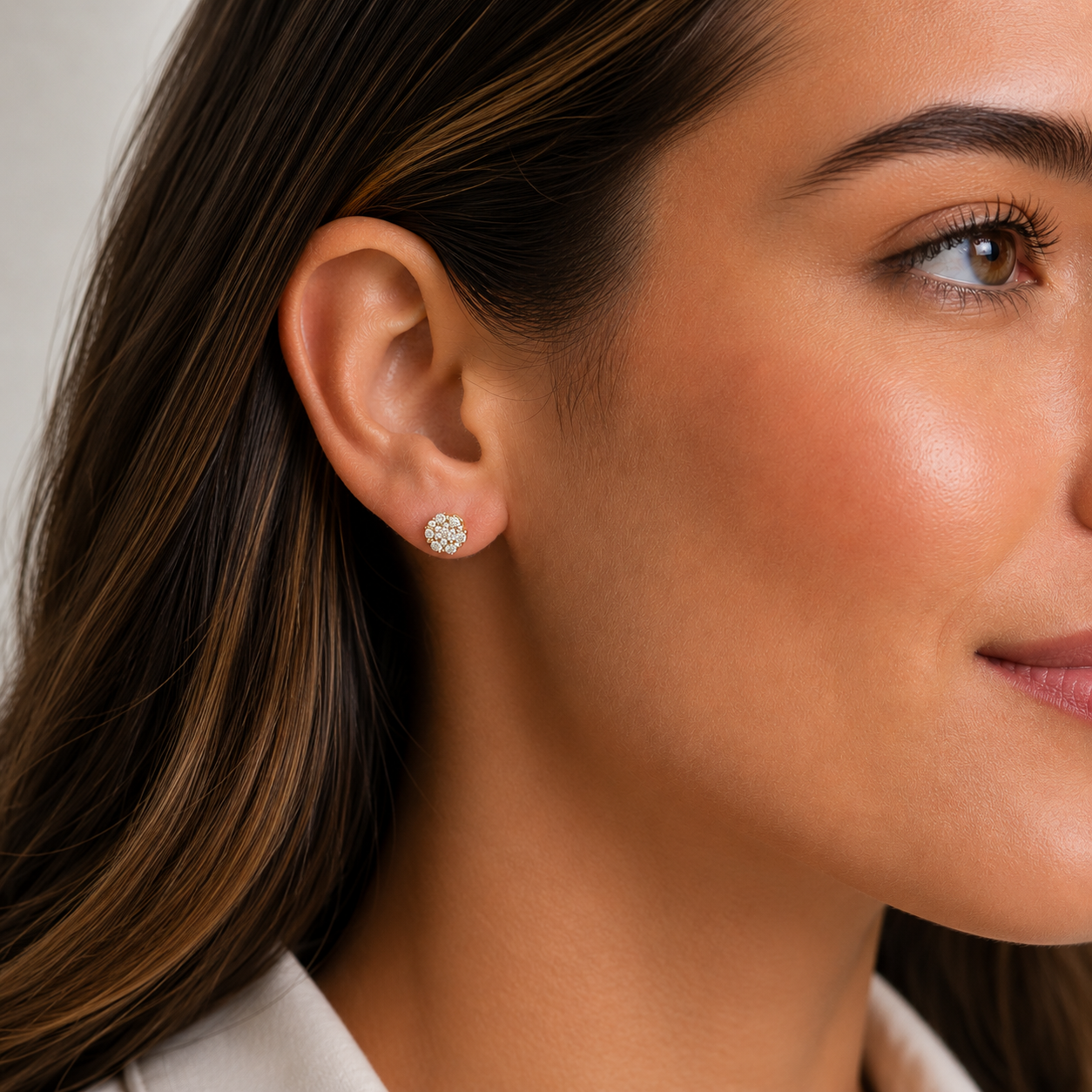 Model wearing natural diamond round cluster stud earrings featuring 0.25 CTW
