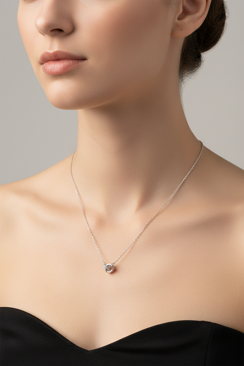 Model wearing sterling silver cable chain necklace with moissanite circle accents.