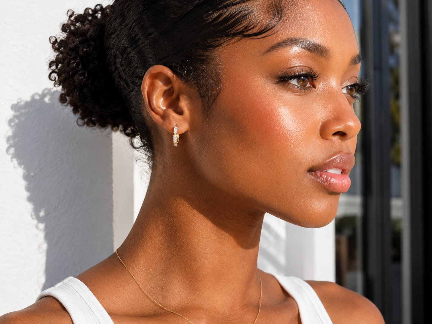 Model wearing natural SI-quality diamond geometric huggie earrings