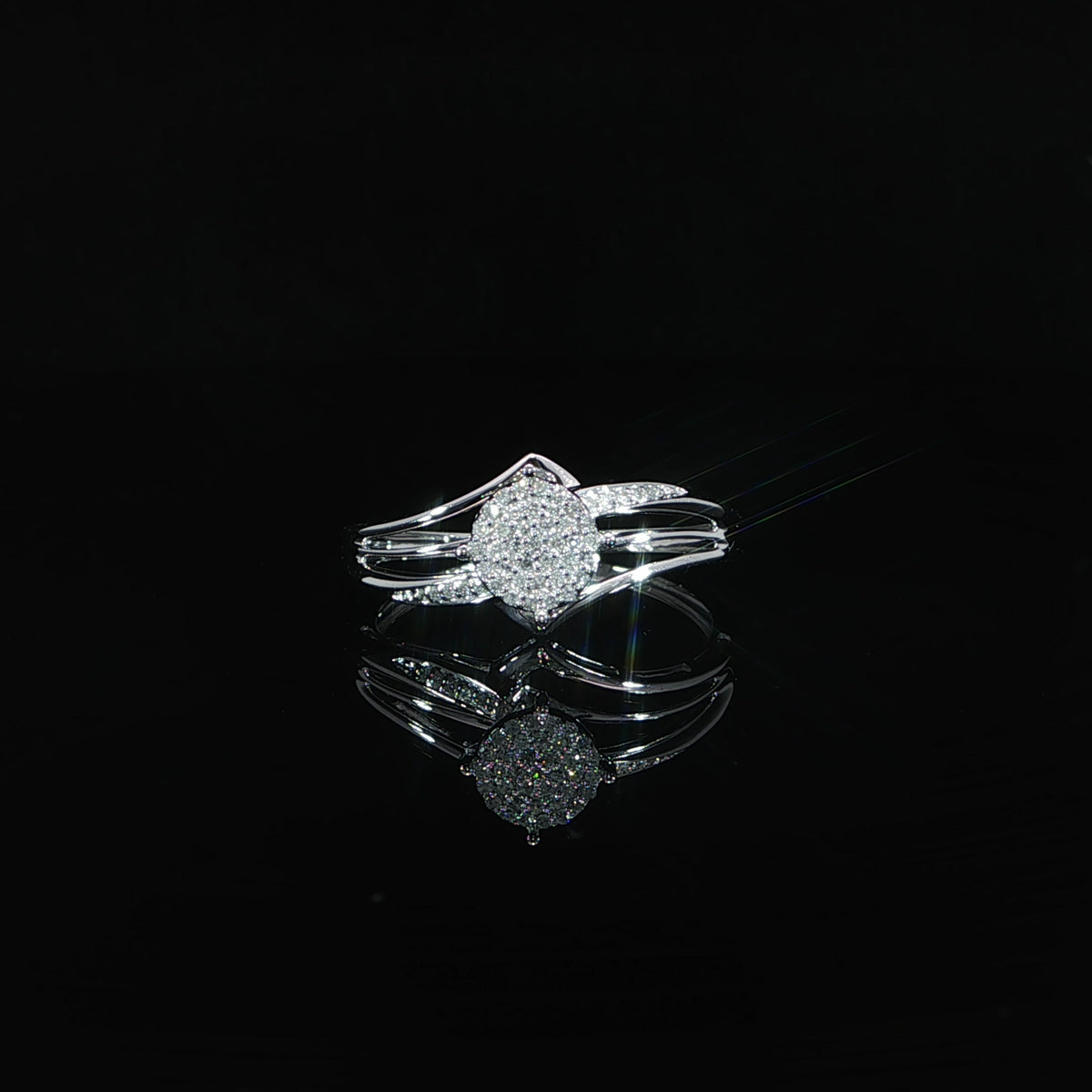 10K gold 0.07 CTW pavé composite ring lying on a reflective black surface