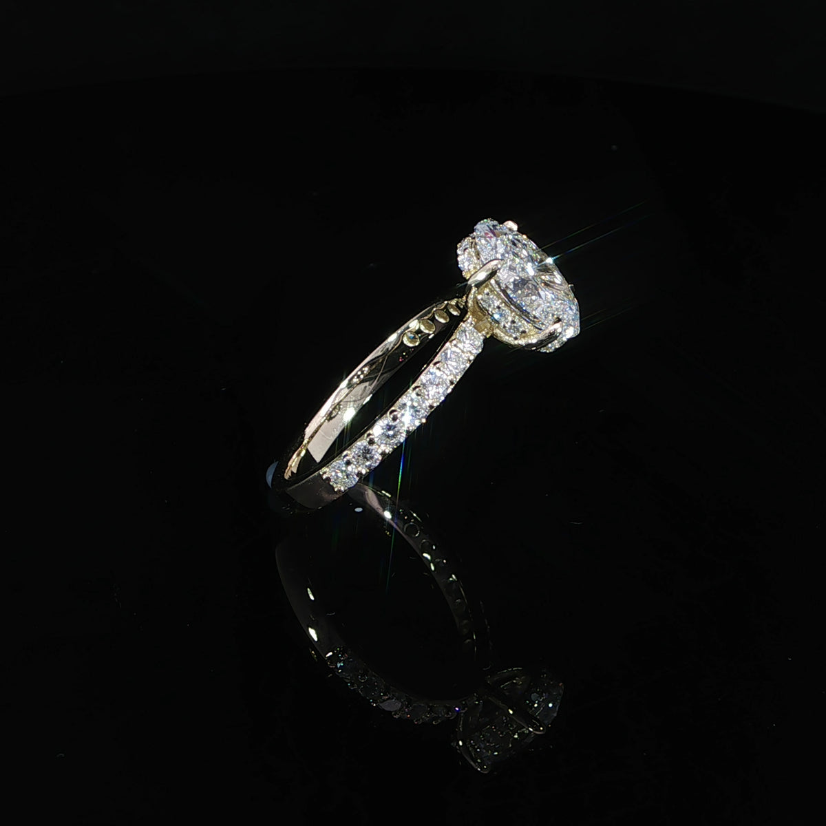 Detailed view of the hidden diamond halo beneath the 2.04-carat oval center stone.