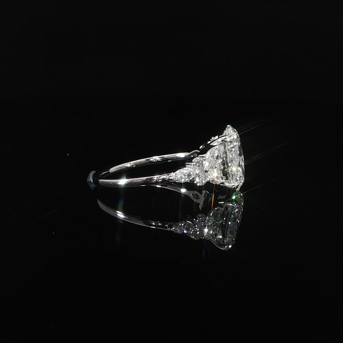 14K white gold oval diamond engagement ring featuring marquise and round diamond side accents.