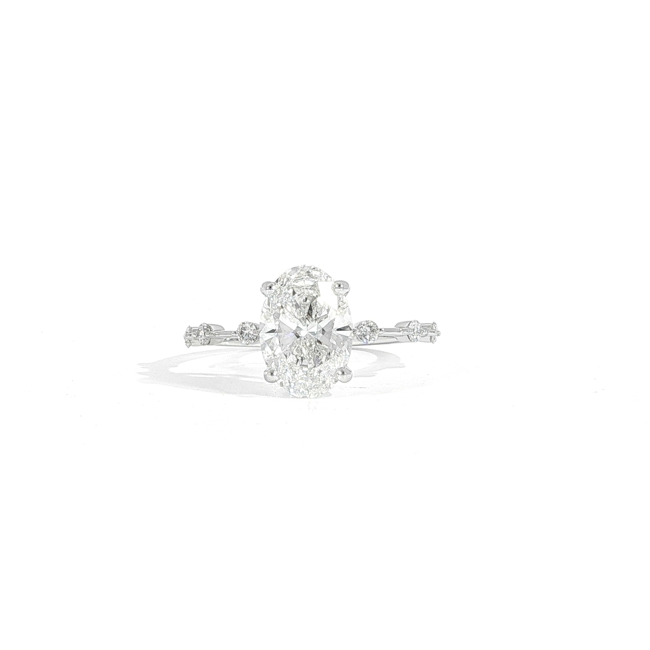 Close-up of oval lab diamond engagement ring with accent stones