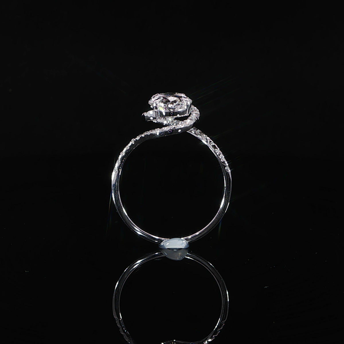 Side profile of an oval lab-grown diamond ring showing its raised halo setting and curved bypass band.