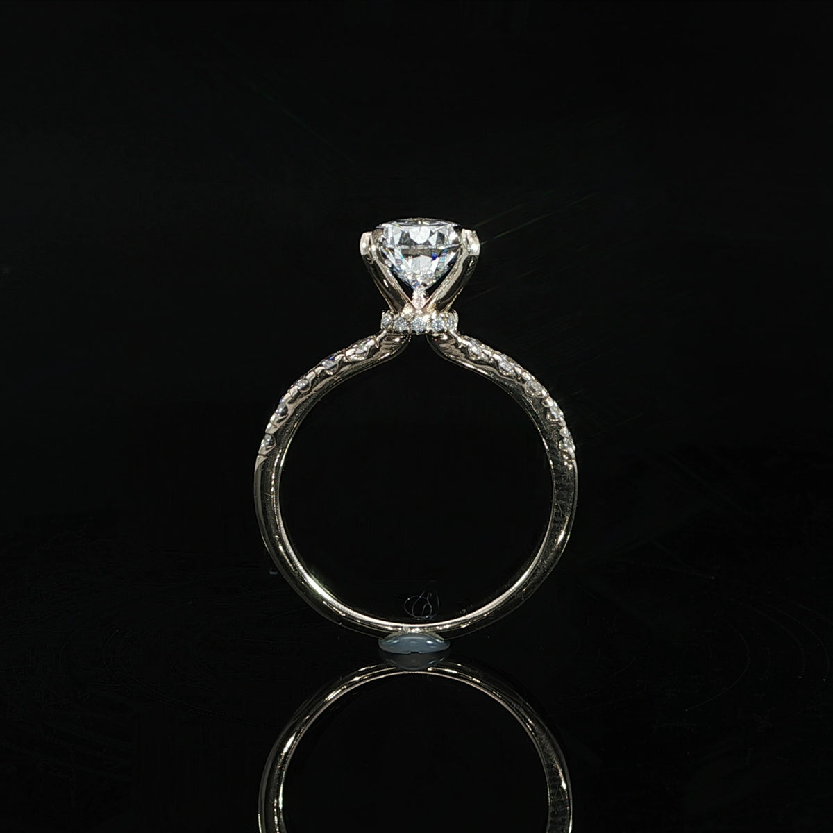Detailed view of the setting supporting the 2.06-carat pear-shaped center diamond.