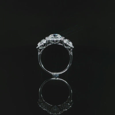 Video of 14k white gold three-stone diamond ring showing the open gallery and polished band