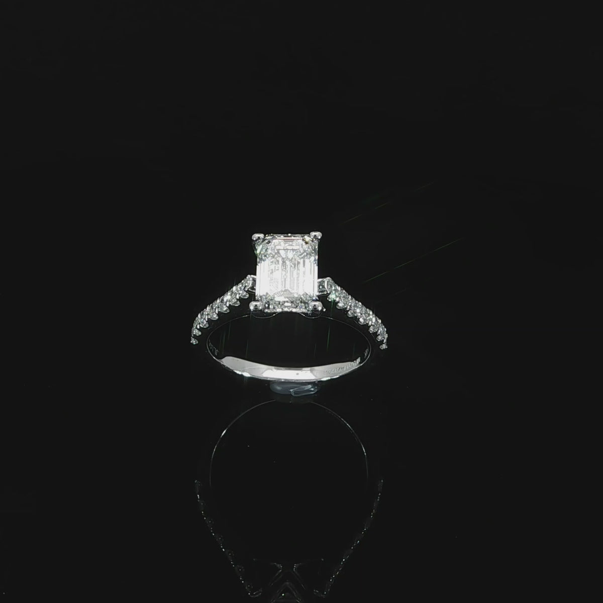 Lab grown emerald cut diamond solitaire engagement ring with cathedral shoulders in 14K white gold.