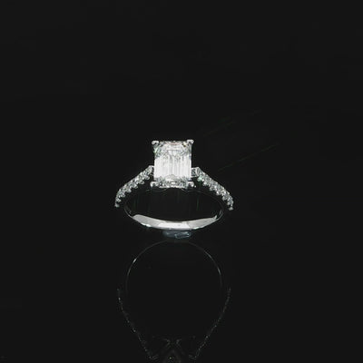 Lab grown emerald cut diamond solitaire engagement ring with cathedral shoulders in 14K white gold.