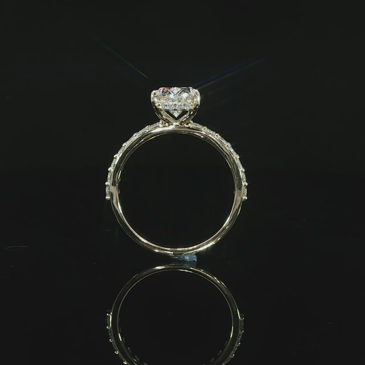 Video of the round diamonds set along the 14K yellow gold engagement ring band.