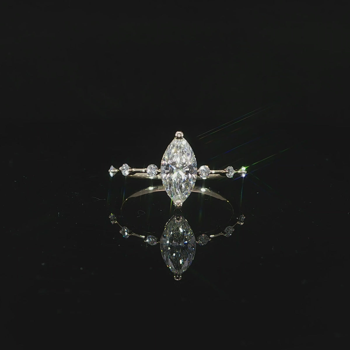 Video of marquise diamond solitaire ring with station diamonds in 14K yellow gold