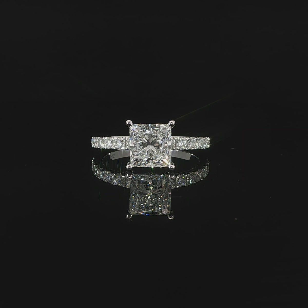 Princess cut engagement ring with sparkling pave-set diamond band in polished 14K white gold.