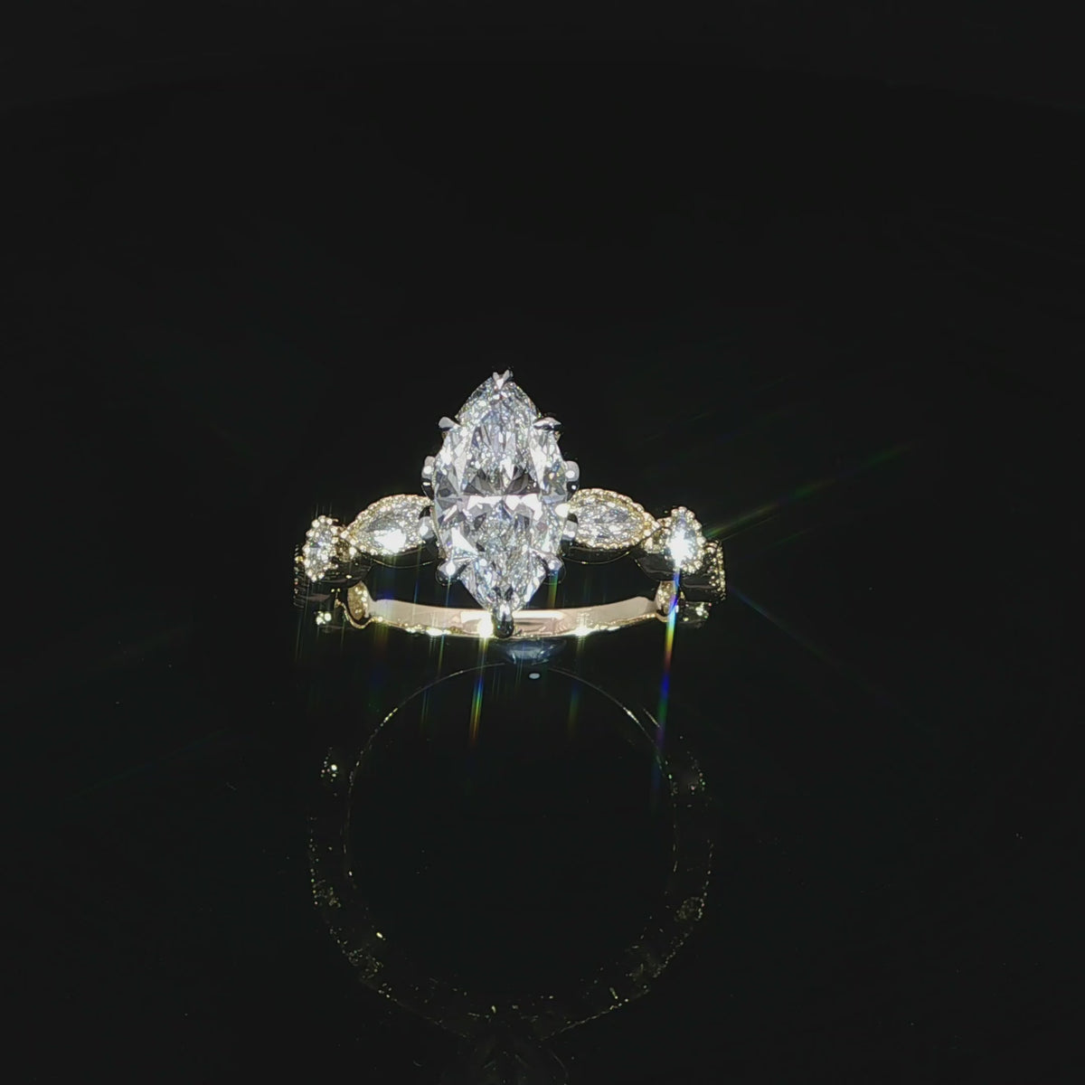 Angled video of gold lab grown marquise diamond ring bezel set band and tulip head