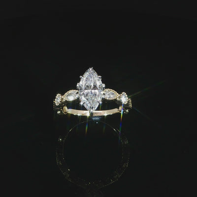Angled video of gold lab grown marquise diamond ring bezel set band and tulip head