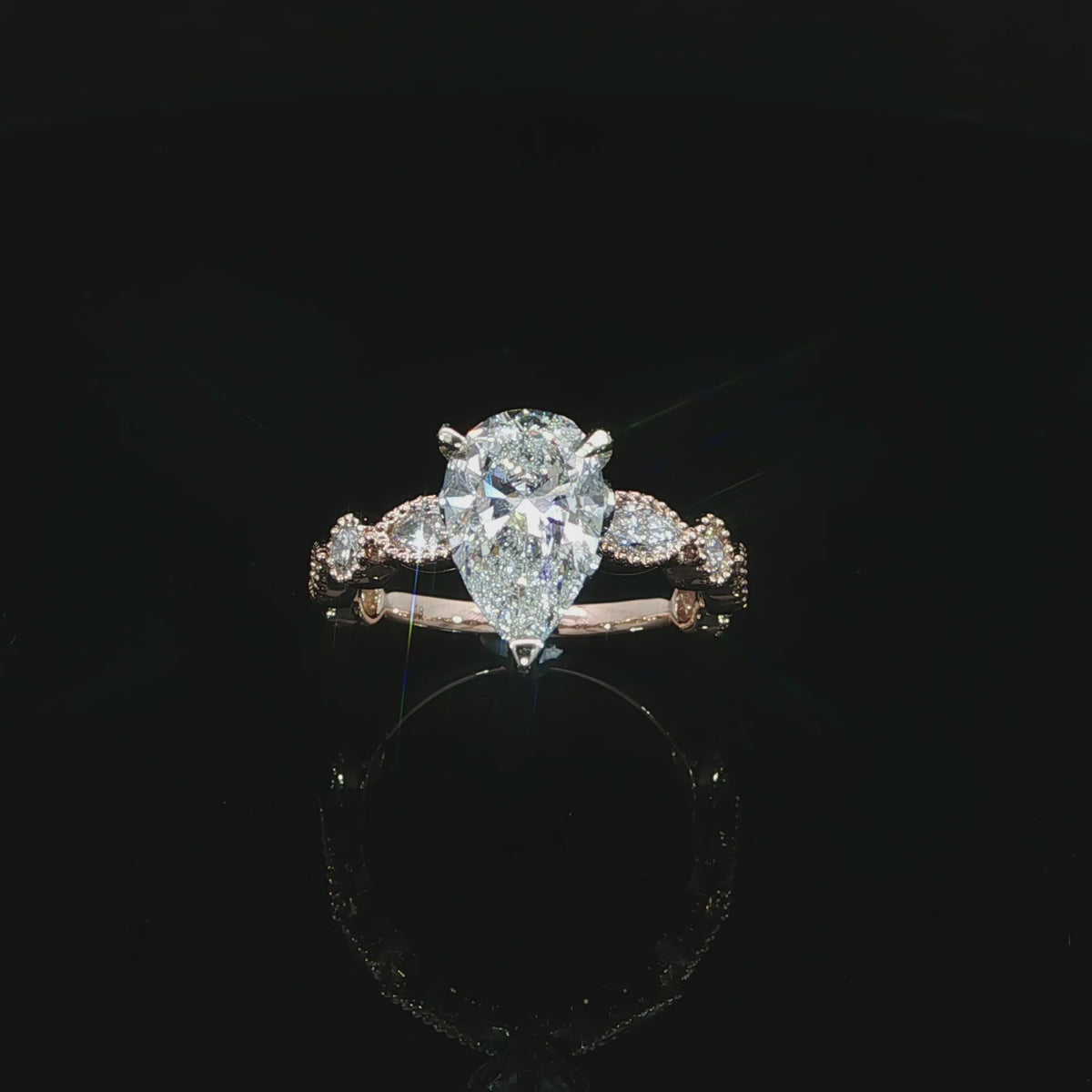 Pear lab grown diamond engagement ring with mixed-shape bezel set side stones in 14K rose gold.