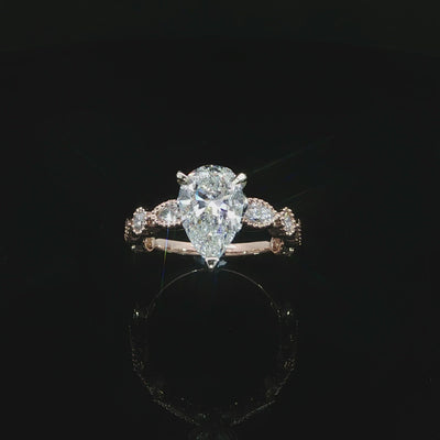 Pear lab grown diamond engagement ring with mixed-shape bezel set side stones in 14K rose gold.