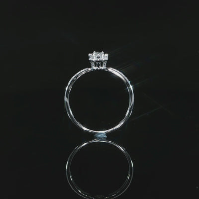 Video of a 10K white gold 0.22 CTW natural diamond illusion ring showing its raised setting and circular band.